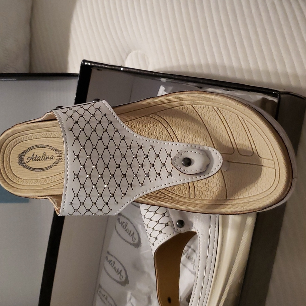 WHITE SHIMMER Thong Sandals with faceted metal studs that sparkle with movement.